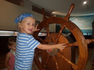 Activities in the Galil - Yakir on a ships wheel at Haifa's Maritime Museum